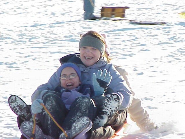 Erika and Alyson sledding